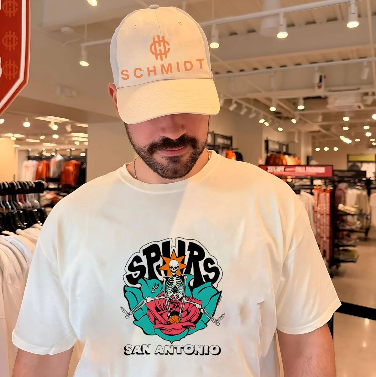 San Antonio Spurs skeletal figure sitting on rose graphic shirt